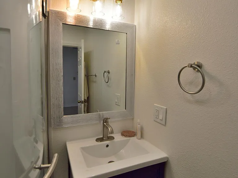 bathroom vanity cabinet, mirror and light
