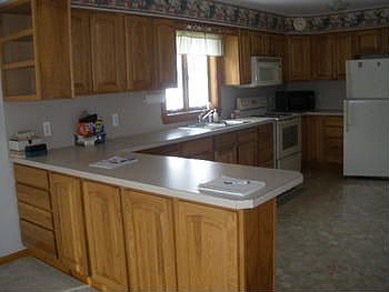bright and roomy kitchen with oak cabinets