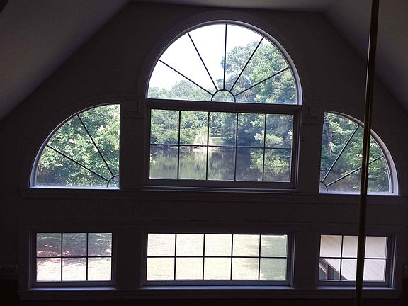 View from the balcony of great room windows showing the pond and trees