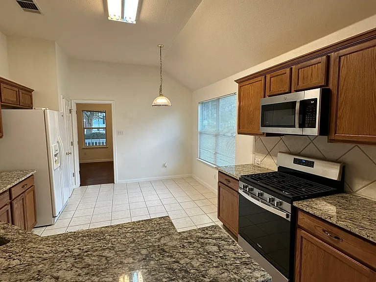 Kitchen and breakfast nook. Note Refrigerator is now stainless. See earlier photo.