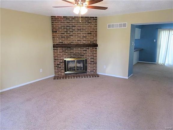 Large family room with cozy, corner wood-burning fireplace.