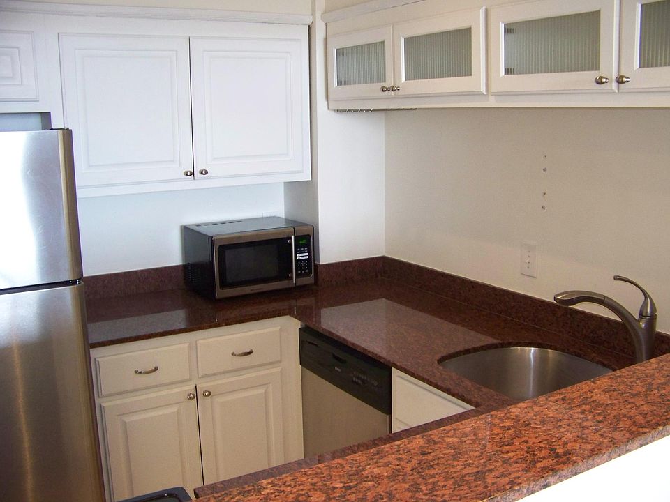 Granite and stainless kitchen with pass-through to living ro