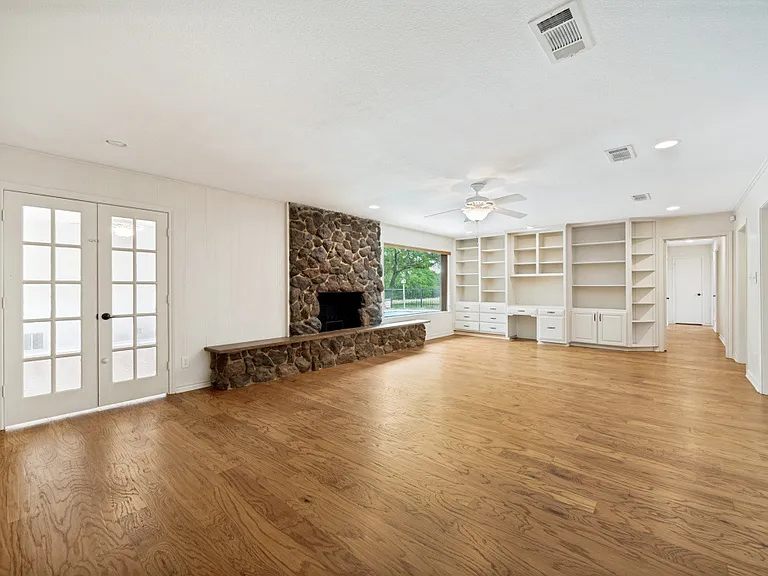 Main living room with fireplace and built-in bookshelves...scenic country view and pool. Entry into private family room.