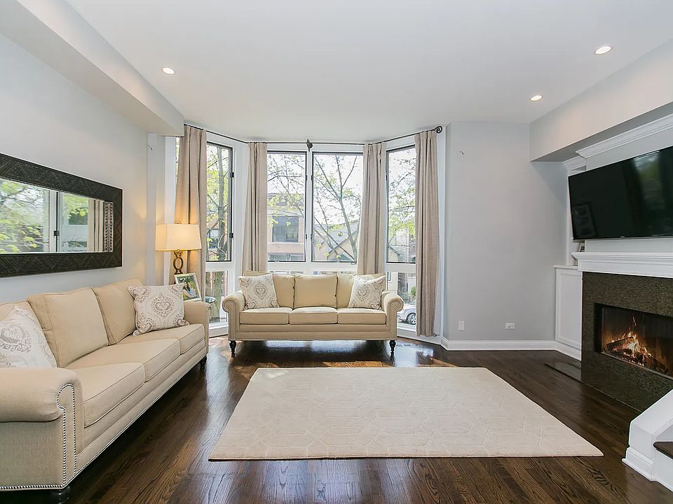 Spacious Living Room with gas fireplace and floor-to-ceiling bay windows