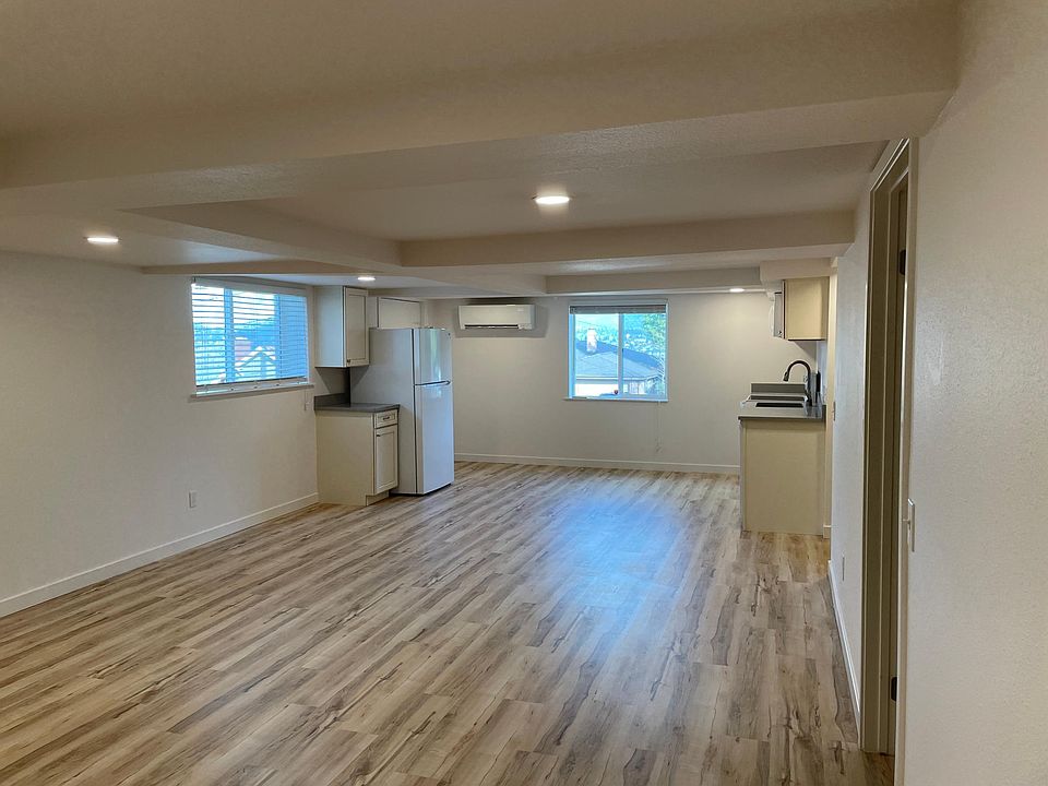 View of kitchen, dining area, and entrance from living area