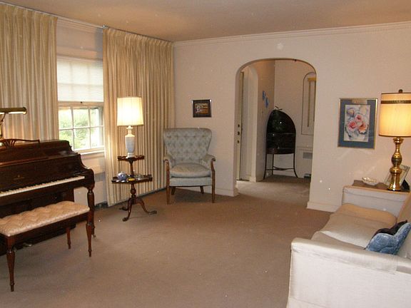 This view of the living room shows the arched entry which leads to entry foyer