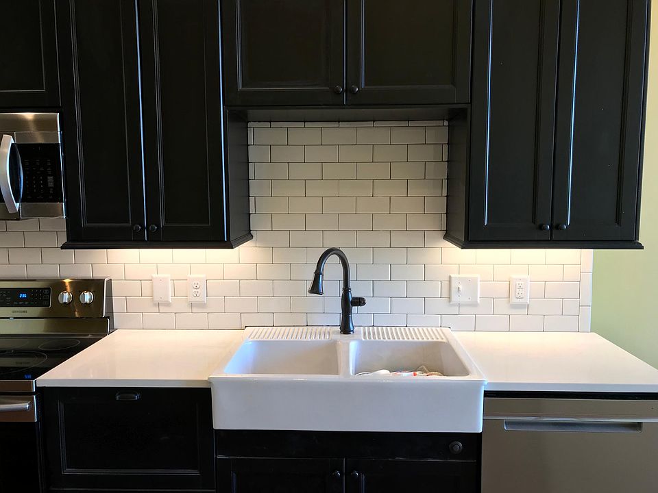 All kitchens feature farmhouse sinks with garbage disposals, quiet dishwashers, subway tile backsplashes, ample cabinet space. Quartz countertops. (Shown-Finished one bedroom/bath kitchen)