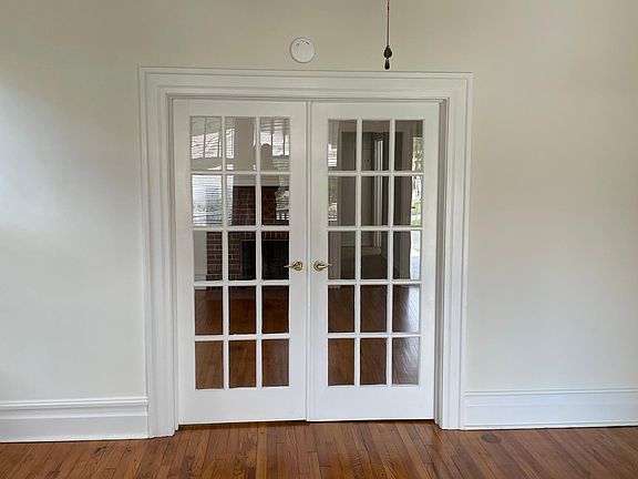 Living room with closed doors leading into dining room