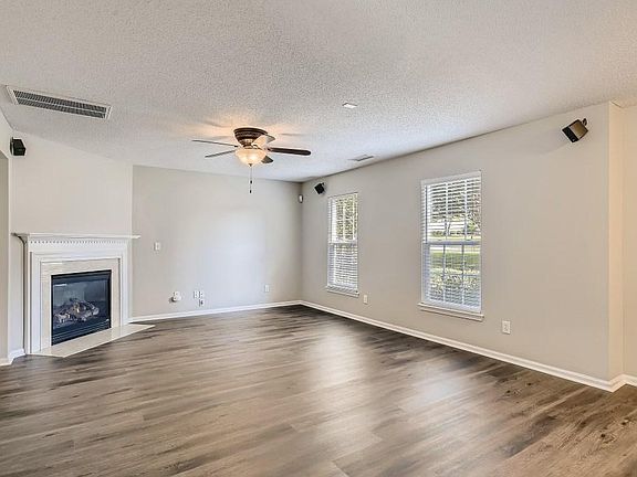 Cozy Family room with ceiling fan and gas fireplace.