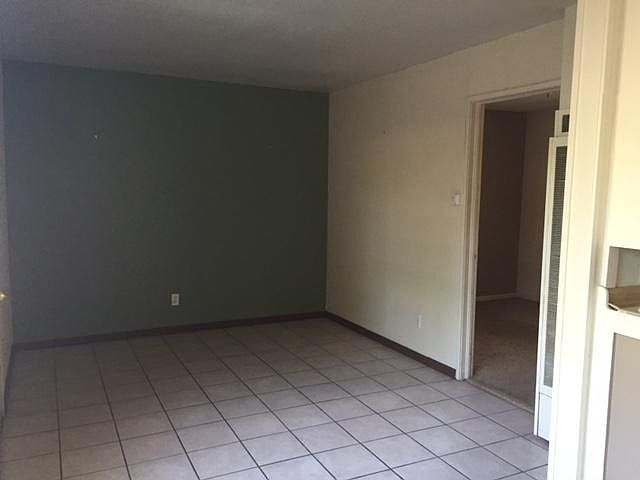 Cozy Living room and door into the currently carpeted bedroom.