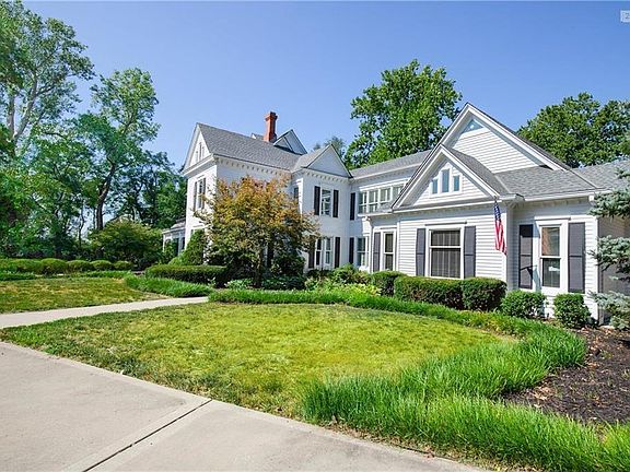 This Beauty sits on about 4 acres of manicured lawn with mature trees and a circle driveway