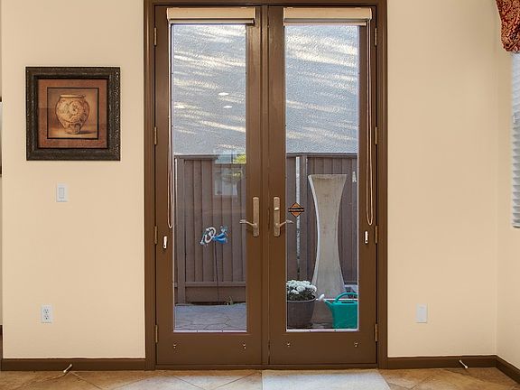 French doors are a designer upgrade as well as decorator items such as curtain valences and art work.