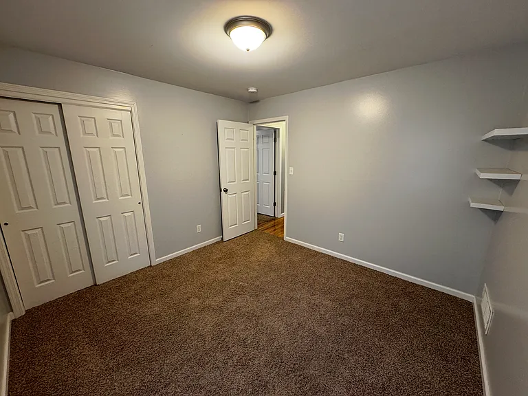 Third room with beautiful floating shelves. This room is ready for office use or perfect use as an extra bedroom. Convenient shelving allows your child to showcasing their achievements.