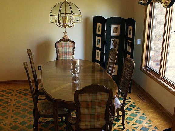 Formal Dining Room with custom tile inlay in wood floors
