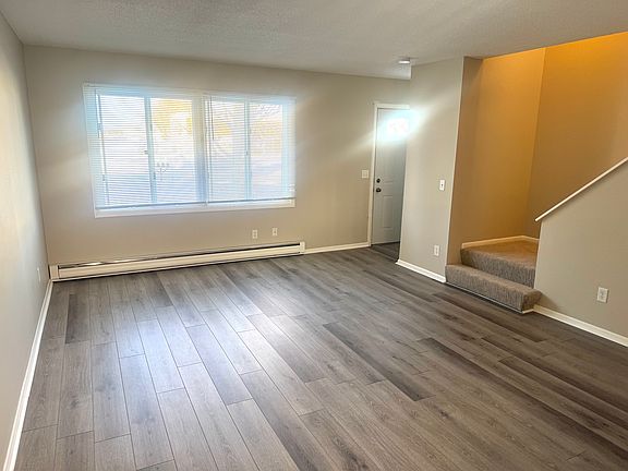 Living room with view of stairs to upstairs.
