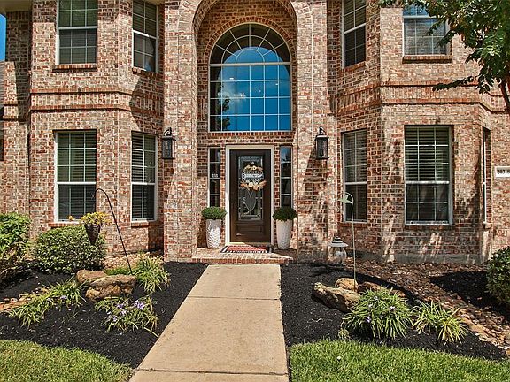 Stunning brick with two story covered brick porch with arch. Stately transom windows offers plenty of diffused lighting in the home.