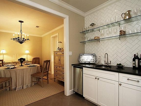 ... crown molding and 9 ft ceilings.  The bar room measures 8 ft x 6 ft and can be accessed from the living room as well as the dining room.