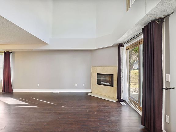 Wood burning fireplace and vaulted ceilings offer a ton of light into the space.