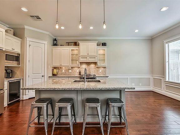 Gorgeous island kitchen with breakfast bar, stainless steel appliances and wine fridge.