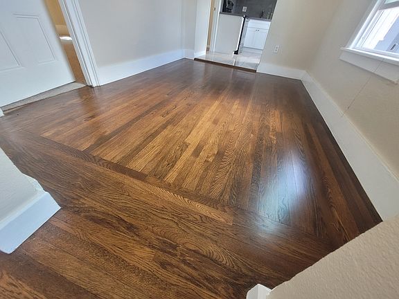 Newly restored original wooden floors are in this upstairs apartment