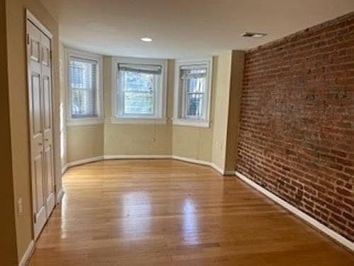 Bed Room with South Facing Windows and original brick wall.