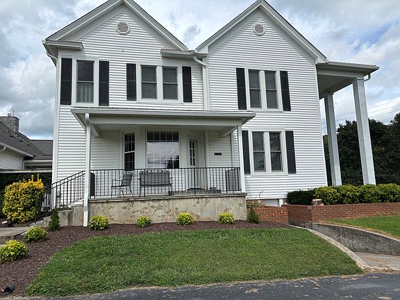 Side porch entrance with parking space for several cars
