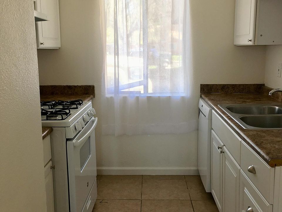 Galley kitchen with newer appliances.