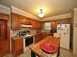 Kitchen - updates include tile flooring, granite countertops, crown molding and designer paint color