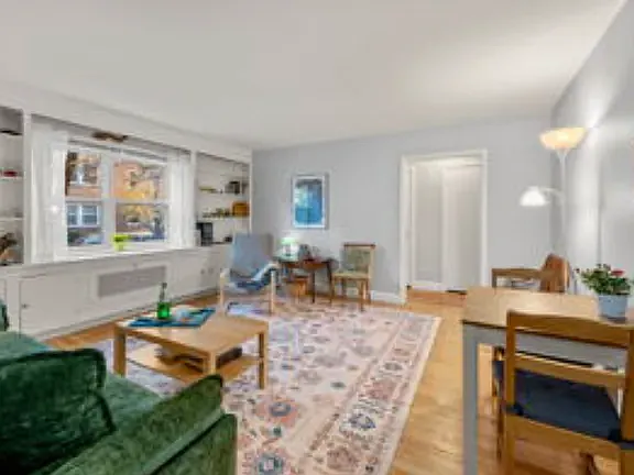 Livingroom, with table for two on the right, plenty of daylight on the left. - 5 Alton Ct #1