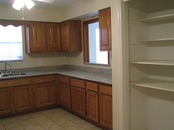 UPSTAIRS: KITCHEN w/Granite countertops, lots of cabinet space, Open Pantry. Pass-thru window to Dining Area