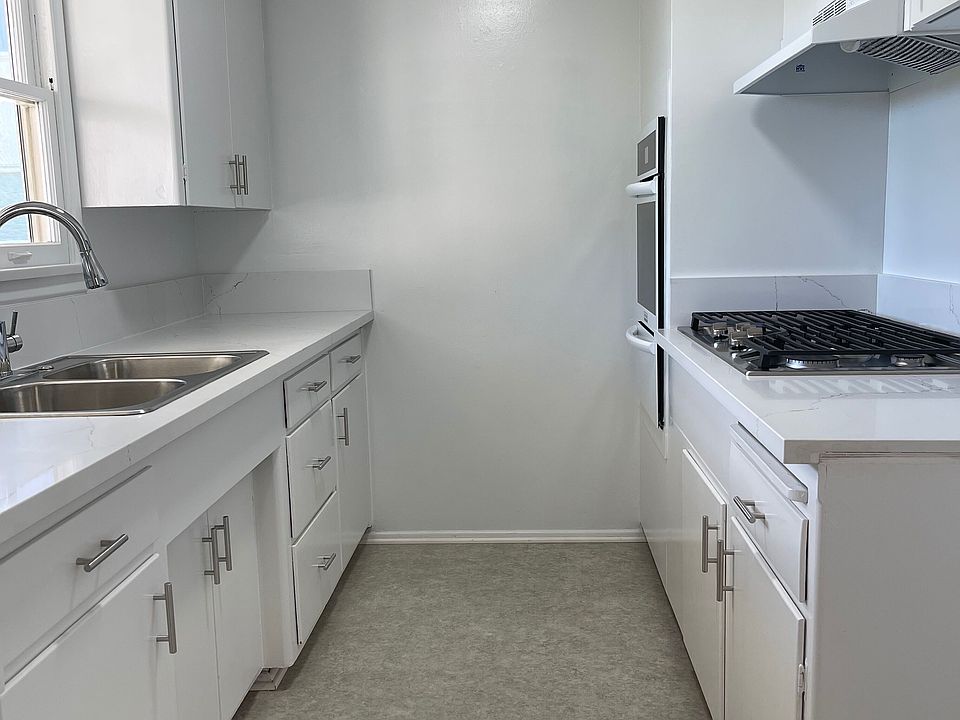 Kitchen with new countertops, new oven, new stove, new sink, new vinyl