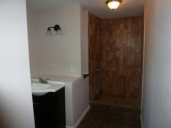 Bathroom with vanity storage and large standing shower