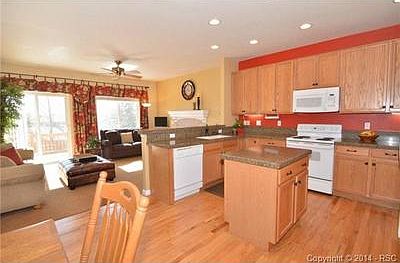 Kitchen with hardwood floors, built in microwave, and island