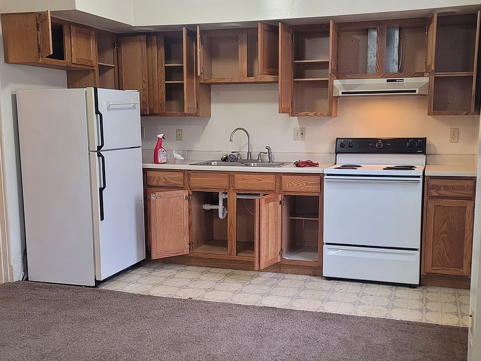 Kitchen with range and refrigerator and lots of cabinets.