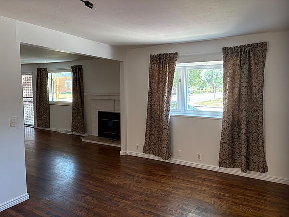 Main floor - taken from dining room - front door, living room, and fireplace
