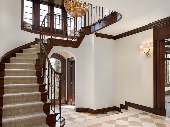 Elegant 2-Story Entry Foyer With Sweeping Staircase and Travertine Tile Floors