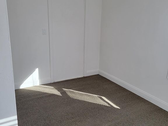 Lower level living room that can be converted into 4th bedroom.