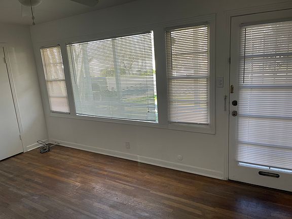 Front room with lots of windows and natural light.