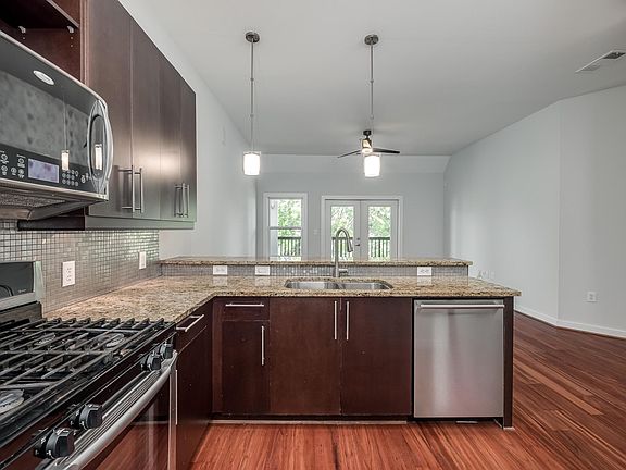 Modern kitchen with stainless appliances.