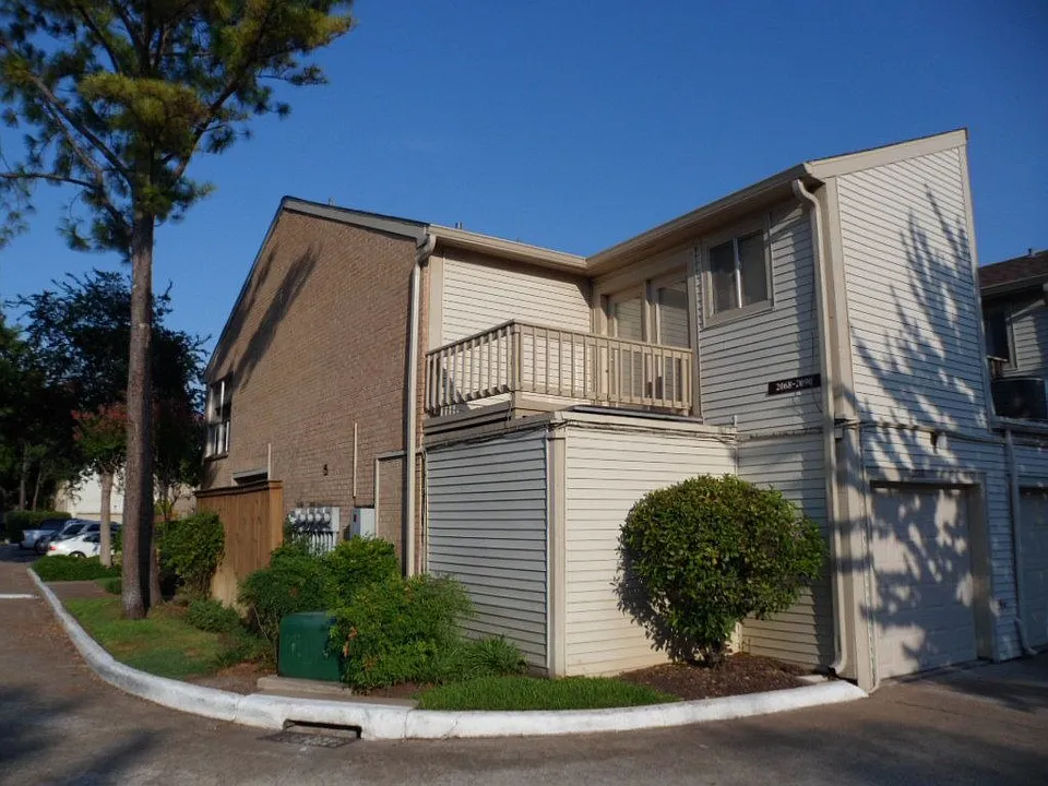 Behind with balcony off guest room and garage