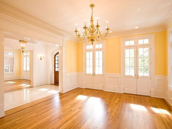 FORMAL DINING ROOM ACCENTED BY GRACEFUL CHANDELIER
