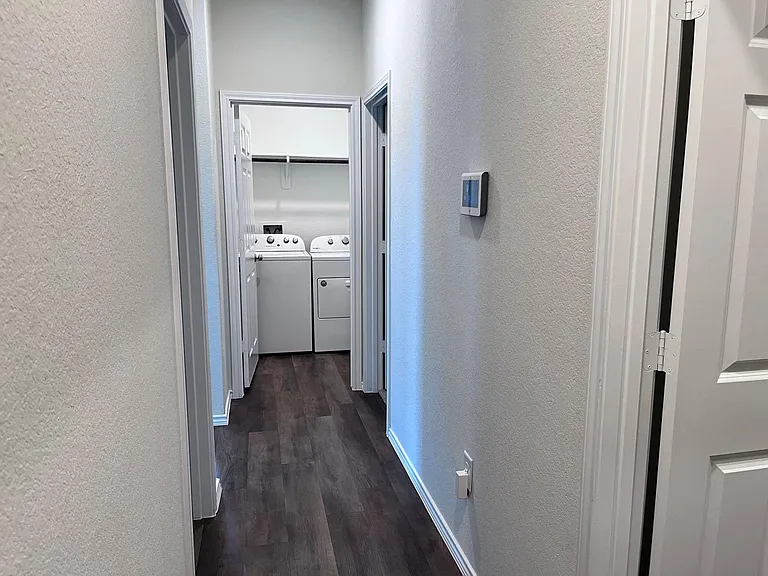 Hallway connecting second, third bedroom with second bathroom and Laundry room.