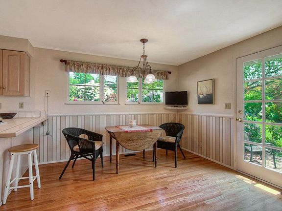 Eating space in kitchen has beautiful hardwood floors and door to private garden patio.