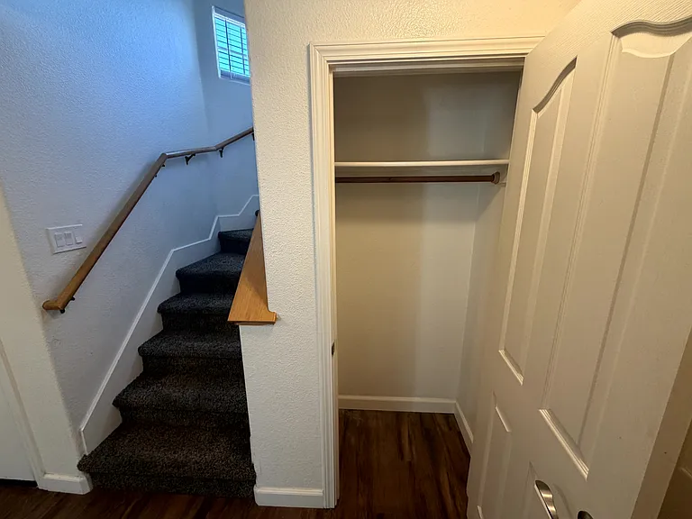 Entry area with coat/storage closet and staircase to the second floor.