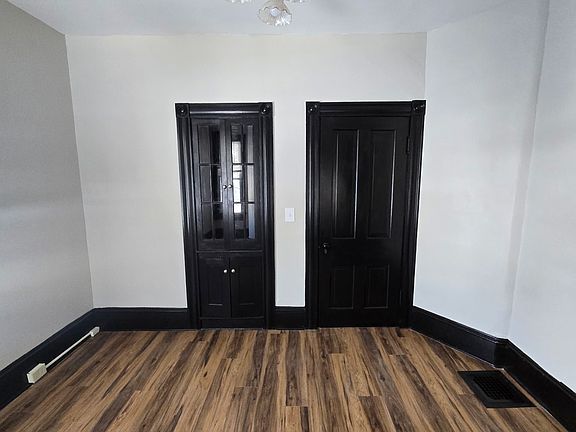 dining room with china cabinet and door to kitchen