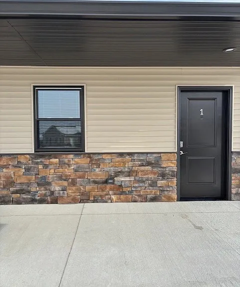 Entry door to apartment and front window