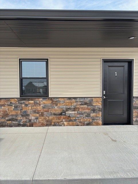 Entry door to apartment and front window