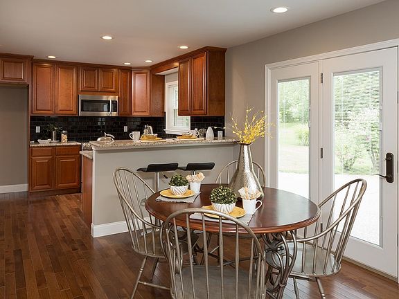Beautifully updated kitchen open to the breakfast room & newer door to the patio & private yard.