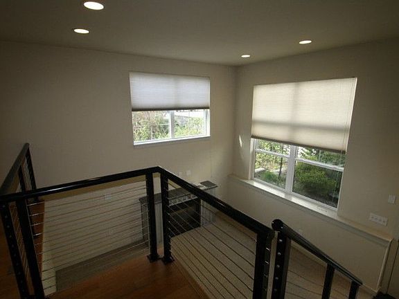 Modern cable railings lead to the dining room and kitchen.