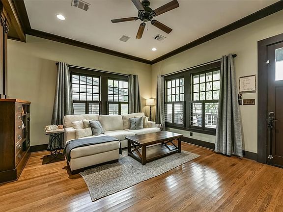 Living room complete with crown moulding, gorgeous built ins, and exquisite woodworking.